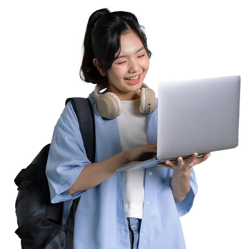 Young woman with headphones around her neck and a backpack smiles while using a laptop to browse Science Tuition resources.